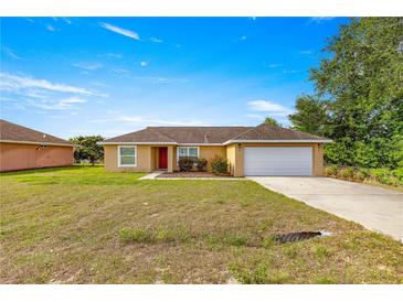 Charming single-story home with a well-maintained front lawn, and a two car garage at 8 Hemlock Radl, Ocala, FL 34472