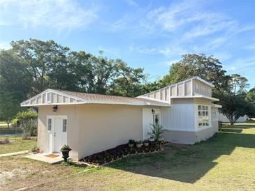 Charming single-story home with unique architectural details and freshly landscaped flower beds at 910 Ne 11Th Ave, Ocala, FL 34470