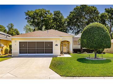 Charming single-story home featuring a well-maintained lawn, attached garage and manicured landscaping at 16299 Sw 14Th Avenue Rd, Ocala, FL 34473