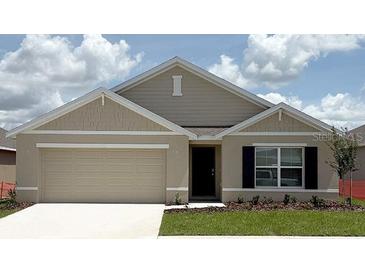 Charming single-story home with a two-car garage, neutral color palette and well-maintained lawn at 4707 Sw 88Th Ln, Ocala, FL 34476