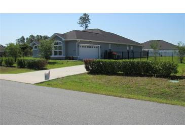 Charming single-story home featuring an attached garage and well-manicured landscaping at 4770 Sw 114Th St, Ocala, FL 34476