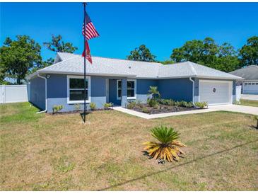 Charming single-story home featuring a well-manicured lawn and attached garage, perfect for a Gathering at 6671 Se 108Th St, Belleview, FL 34420