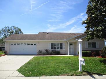 Charming single-story home featuring a well-maintained lawn and attached two-car garage at 11536 Sw 138Th Ln, Dunnellon, FL 34432