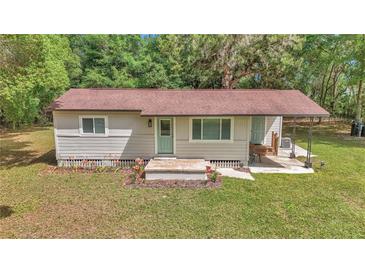 Charming one-story home with a well-manicured lawn, fresh landscaping and a lovely front porch at 4180 W Anthony Rd, Ocala, FL 34475