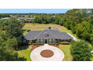 Stunning home with a circular driveway and beautiful landscaping at 5484 Sw 30Th Ave, Ocala, FL 34471