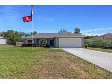 Charming single-story home with well-maintained lawn and driveway at 5899 Pecan Rd, Ocala, FL 34472