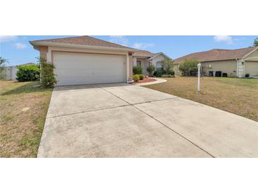 Charming single-story home features a well-maintained lawn, and a two-car garage at 8127 Sw 60Th Ct, Ocala, FL 34476