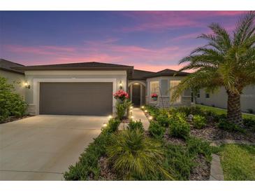 Charming single-story home boasts lush landscaping, a two-car garage, and a welcoming front entrance at 8875 Sw 58Th Street Rd, Ocala, FL 34481