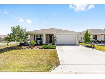 Charming single-story home featuring a well-manicured lawn and attached two-car garage at 8952 Sw 79Th Ln, Ocala, FL 34481