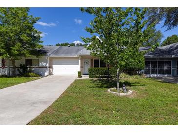 Charming single story home featuring a two-car garage, manicured lawn, and inviting front entrance at 9638 Sw 94Th Ave # C, Ocala, FL 34481