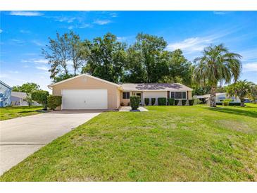 Charming single-story home with a well-manicured lawn and mature trees at 10833 Sw 86Th Ter, Ocala, FL 34481