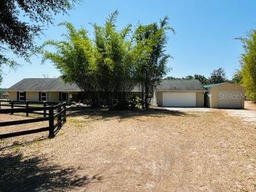 Charming ranch-style home featuring mature bamboo and a two-car garage, set on a spacious lot at 15069 Se 73Rd Ave, Summerfield, FL 34491