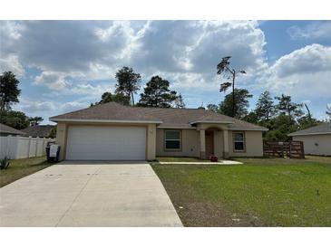 Charming single-story home featuring a two-car garage, well-maintained lawn, and neutral exterior paint at 15976 Sw 23Rd Court Rd, Ocala, FL 34473
