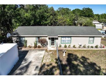 Charming single-story home with a well-maintained lawn, bordered by a line of shrubs at 2808 Ne 24Th Ct, Ocala, FL 34470