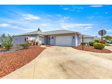 Charming single-story home with a well-maintained front yard and a two-car garage at 3017 Moultrie Way, The Villages, FL 32162