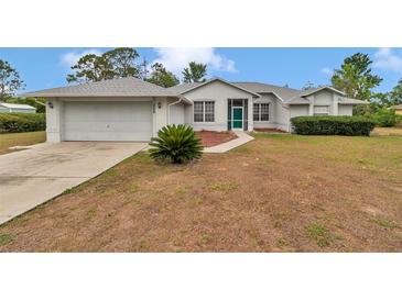 Charming single-story home featuring an attached two-car garage and a well-manicured front yard at 5331 Old Hickory Ln, Fruitland Park, FL 34731