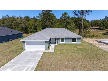 Charming single-Gathering home featuring a two-car garage and well-manicured lawn at 6756 Sw 151St Loop, Ocala, FL 34473