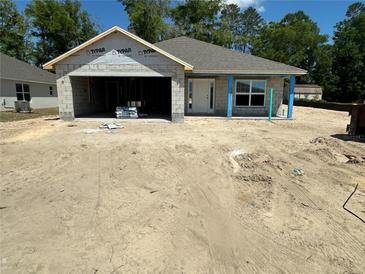 Unfinished single-story home with a two-car garage awaiting completion in a construction phase at 3107 Ne 46Th Ave, Ocala, FL 34470