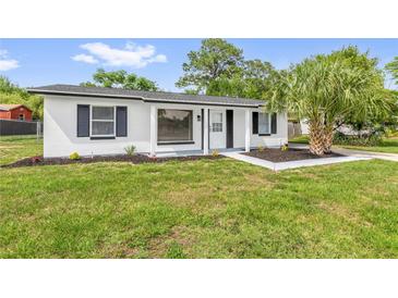 Charming single-story home featuring a fresh white exterior, black shutters, and a well-manicured lawn at 3807 Sw 143Rd Lane Rd, Ocala, FL 34473