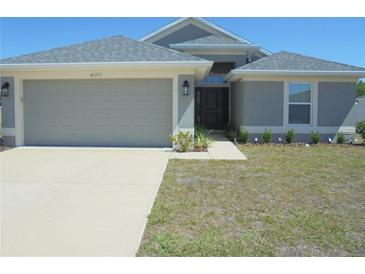 Charming single-story home featuring a well-manicured lawn and a two-car garage at 4373 Ne 31St St, Ocala, FL 34470