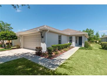 Well-maintained exterior showcasing a lovely home with a manicured lawn at 7249 Sw 93Rd Ave, Ocala, FL 34481