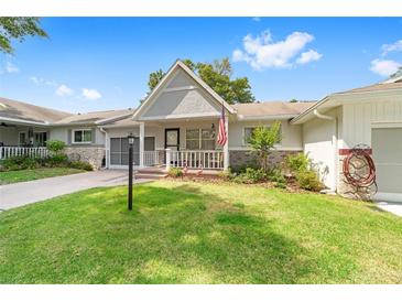 Charming single-story home featuring a well-maintained lawn and inviting front porch at 9333 Sw 97Th Pl # C, Ocala, FL 34481