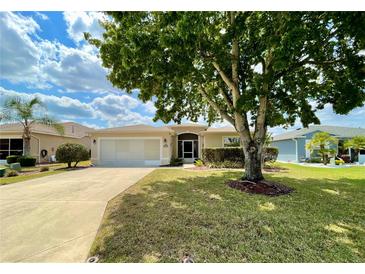 Well-maintained single Gathering home featuring a lush green lawn and mature landscaping at 15782 Sw 16Th Avenue Rd, Ocala, FL 34473