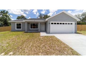 Charming single-story home featuring a two-car garage and a well-maintained lawn at 28 Olive Dr, Ocala, FL 34472