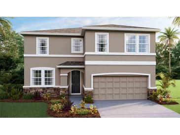 Charming two-story home featuring a stone-accented facade, attached garage, and a well-manicured lawn at 4172 Sw 53Rd Lane Rd, Ocala, FL 34474