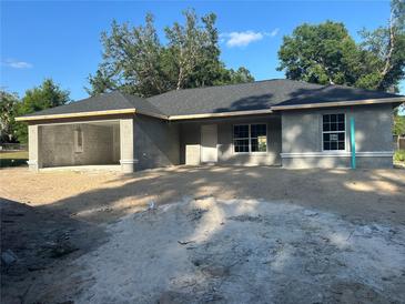 New construction home featuring a gray exterior and a covered two car port at 2871 Se 145 Pl, Summerfield, FL 34491