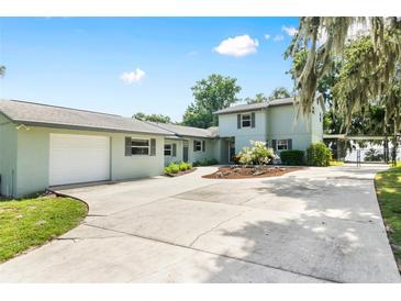 Charming two-story home with a spacious driveway, well-maintained landscaping, and a detached two-car garage at 4237 Chambers St, Lake Wales, FL 33898