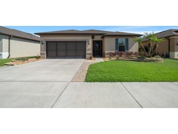Charming single-story home featuring a well-manicured lawn, neutral paint, and a two car garage at 6376 Sw 97Th Terrace Rd, Ocala, FL 34481