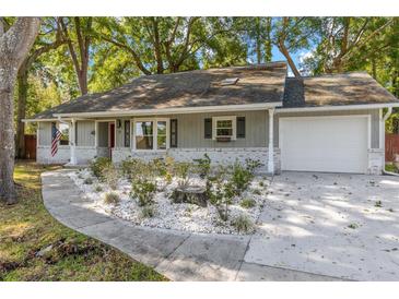 Charming single-story home featuring a well-manicured yard and attached garage, perfect for suburban living at 8 Banyan Dr, Ocala, FL 34472