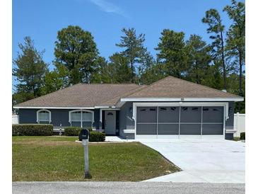 Charming single-story home with a well-manicured lawn and a spacious two-car garage at 15266 Sw 44Th Ter, Ocala, FL 34473