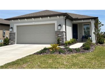 Charming single-Gathering home with a well-manicured lawn, stone accents, and a two-car garage at 5785 Sw 87Th Court Rd, Ocala, FL 34481