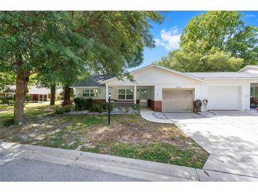 Charming single-story home featuring a well-kept lawn and attached one-car garage on a sunny day at 9855 Sw 85Th Terrace Rd # A, Ocala, FL 34481