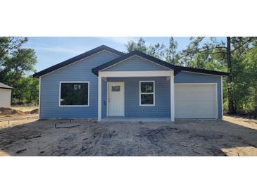 Charming single-story home with blue siding and attached one car garage at 1598 Sw 152Nd Ct, Ocala, FL 34481