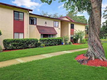 Well-maintained multi-Gathering unit with lush landscaping, including healthy green grass and mature trees at 700 Midway Dr # B, Ocala, FL 34472