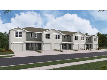Newly constructed townhomes boasting modern architectural designs and attached garages at 8407 Gower Trl, Wildwood, FL 34785