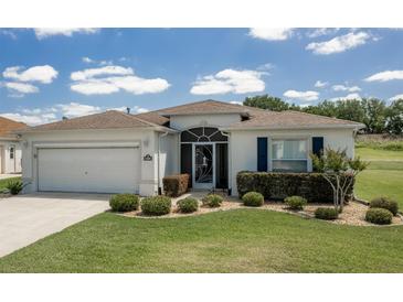 Charming single-story home with a well-manicured lawn and an attached two-car garage at 15691 Sw 11Th Court Rd, Ocala, FL 34473