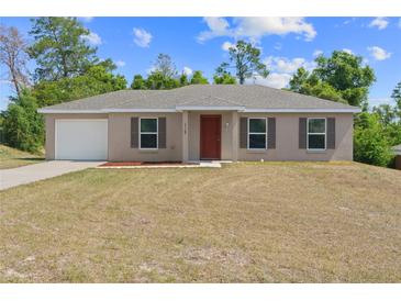 Charming single-story home featuring a front-facing garage and a well-maintained lawn at 17147 Sw 42Nd Ct, Ocala, FL 34473