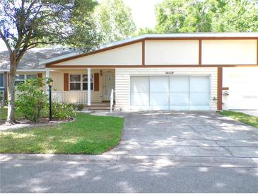 Charming single-story home featuring a well-manicured lawn and a two-car garage at 8653 Sw 95Th Ln # F, Ocala, FL 34481