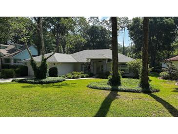 Charming single-story home boasts lush landscaping, a manicured lawn, and mature trees for enhanced curb appeal at 9129 Sw 193Rd Cir, Dunnellon, FL 34432