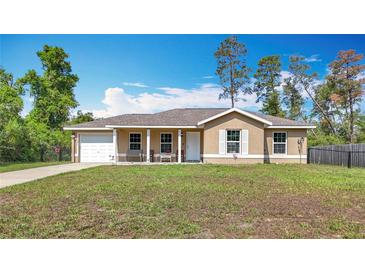 Charming one-story home featuring a covered porch, single car garage, and a well-maintained front lawn at 15640 Sw 48 Ave, Ocala, FL 34473