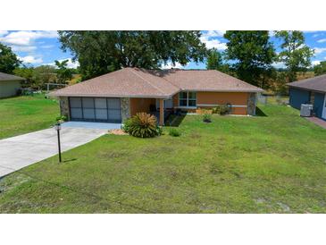 Charming single-story home with a well-maintained lawn and inviting curb appeal at 21425 Sw Plantation St, Dunnellon, FL 34431
