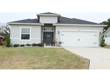 Charming single-Gathering home featuring a well-manicured lawn and a two-car garage at 5515 Se 91St St, Ocala, FL 34480