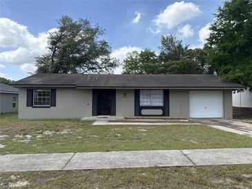 Charming single-story home featuring a well-kept lawn and classic design elements at 15036 Sw 35Th Cir, Ocala, FL 34473
