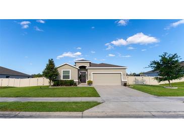 Charming single-story home features a well-manicured lawn, a two car garage, and a lovely front door at 1509 Ne 50Th Ter, Ocala, FL 34470