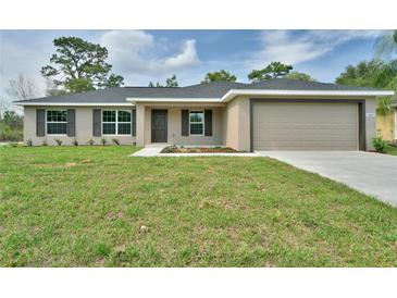 Charming single-story home with manicured lawn and neutral paint, exuding curb appeal at 16219 Sw 48Th Cir, Ocala, FL 34473