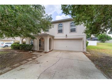 Charming two-story home featuring a two-car garage, arched entry, and well-maintained landscaping at 4624 Se 32Nd Pl, Ocala, FL 34480